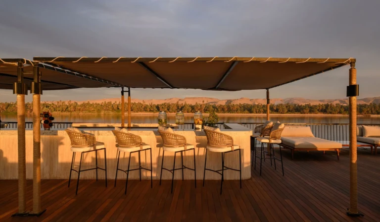 Bar stools under a canopy with Nile view on the Le Fayan sun deck