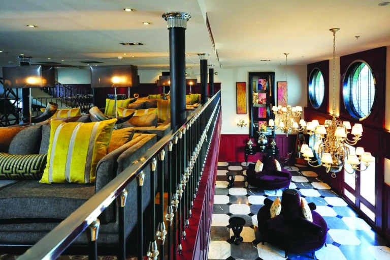 Mezzanine lounge with cushions and porthole windows on the MS Mayfair