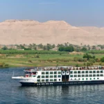 MS Mayflower cruise ship sailing the Nile below desert hills