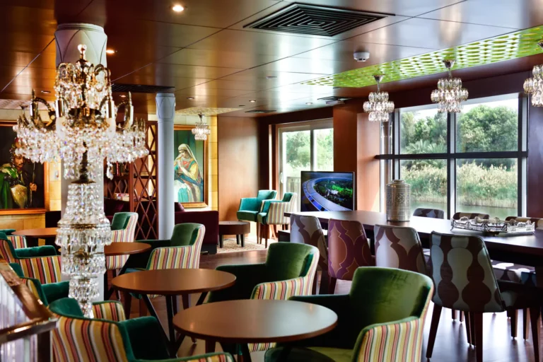 MS Mayflower lounge with chandelier and green armchairs