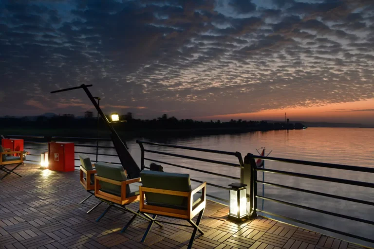 Deck chairs and lanterns at dusk on MS Mayflower