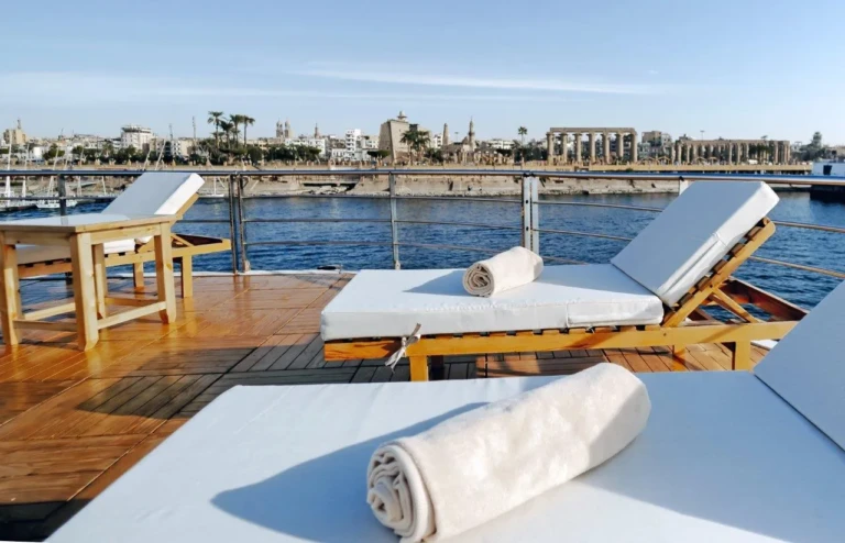 Sun loungers with rolled towels on deck overlooking the Nile