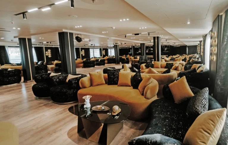 Lounge with mustard and black sofas and cushions