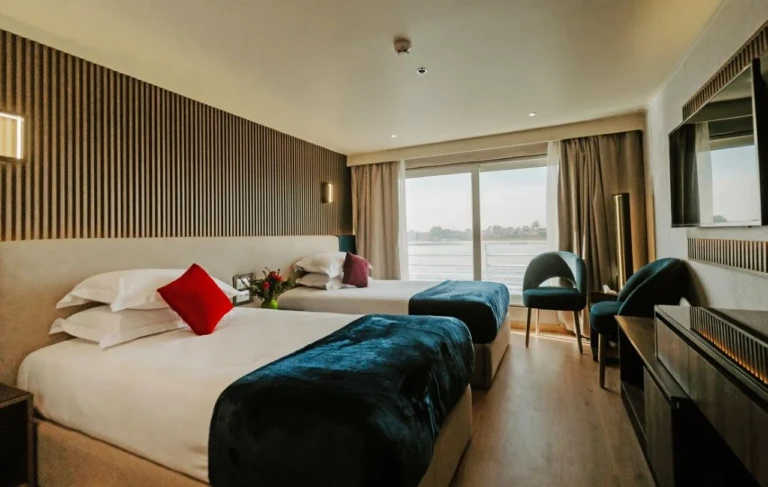Twin cabin with red cushions and panoramic window