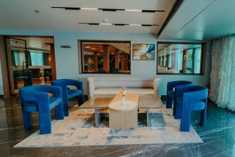 Lobby seating area with blue armchairs on MS Miriam