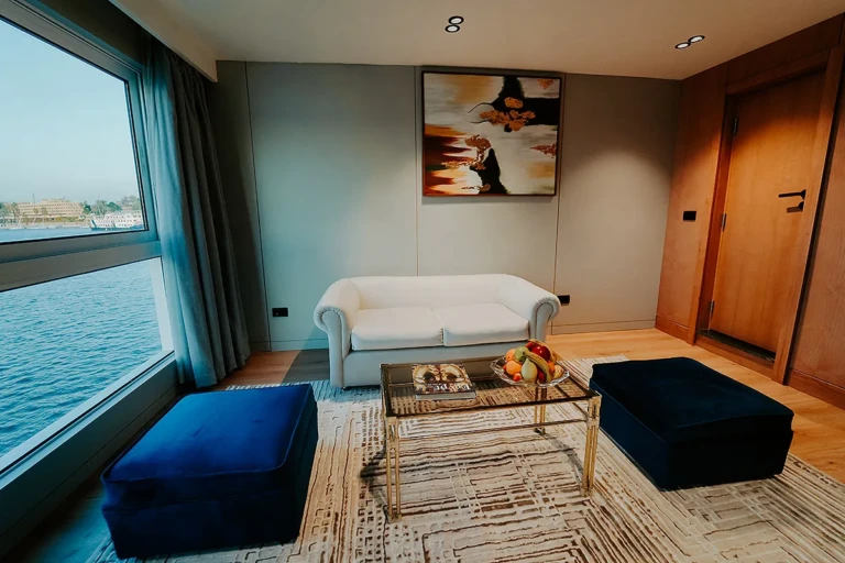 MS Miriam suite lounge with painting and blue velvet ottomans