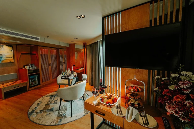 Suite lounge with armchair and fruit platter on MS Miriam
