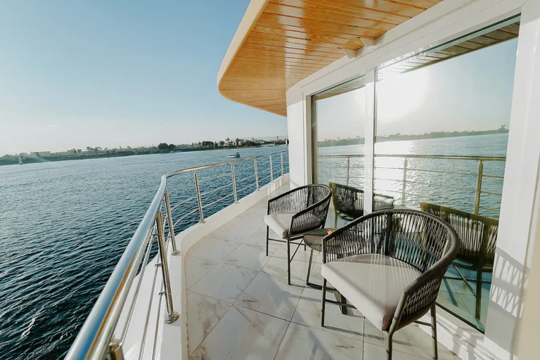 Private balcony with wicker chairs overlooking the Nile on MS Miriam