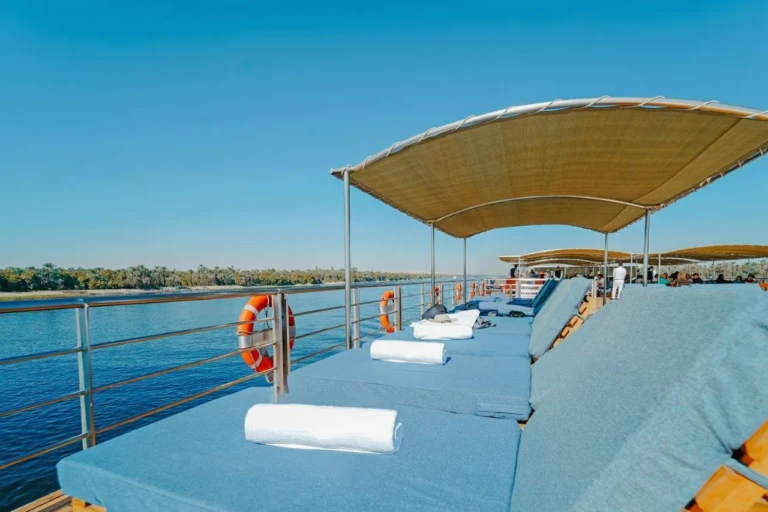 Shaded sun loungers with rolled towels on MS Miriam deck