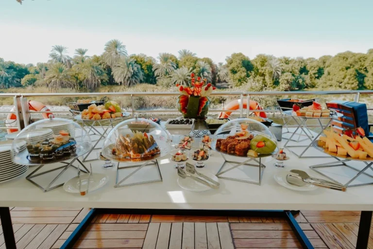 Outdoor buffet with covered dishes on the MS Miriam deck