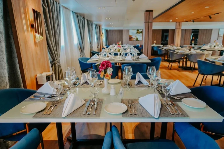 Place settings with white napkins at an MS Miriam restaurant table