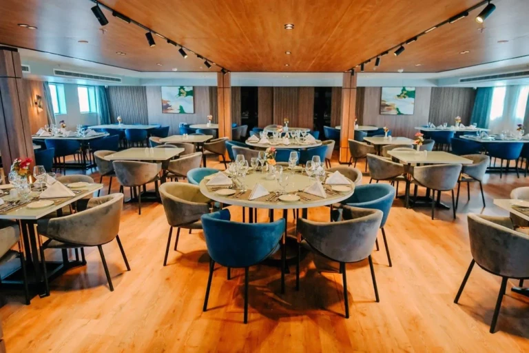 MS Miriam restaurant with round tables and blue chairs