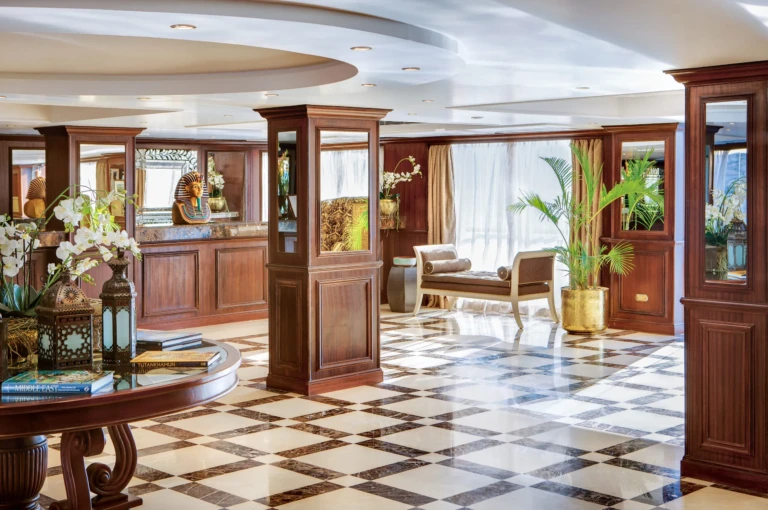 Reception with checkerboard marble floor and wooden pillars