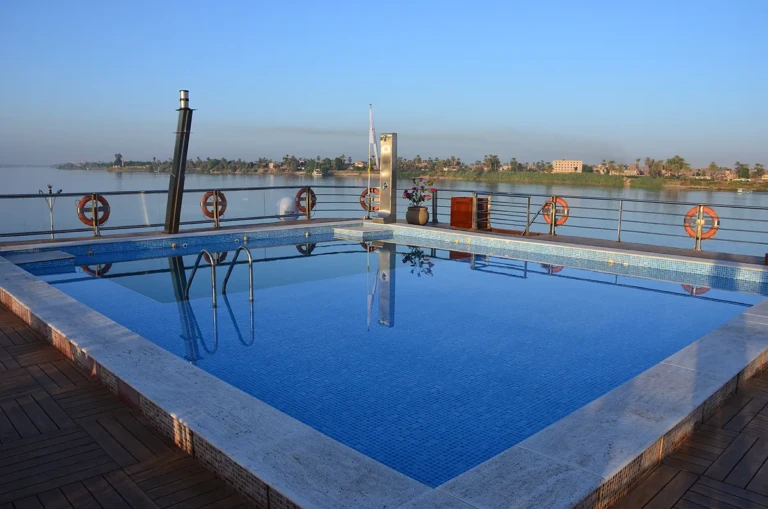 Deck pool at dusk with life rings and the Nile beyond