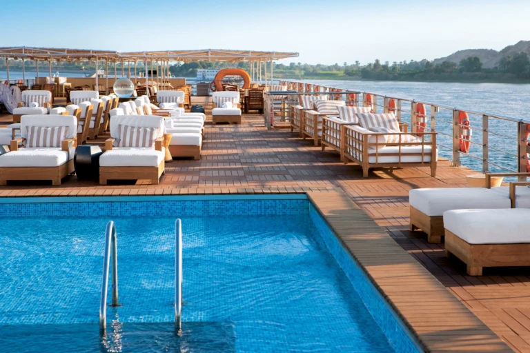Sun deck pool with white loungers along the rail