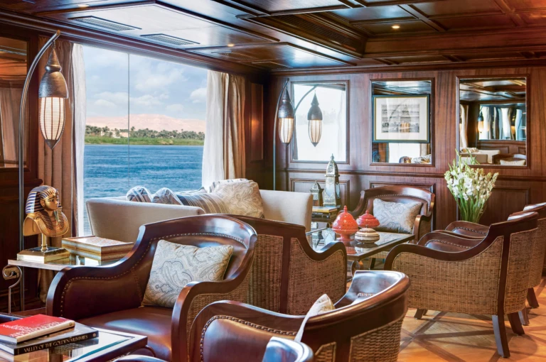 Lounge with leather armchairs and a Nile view window