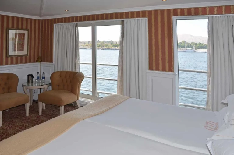 Cabin armchairs by French windows facing the Nile
