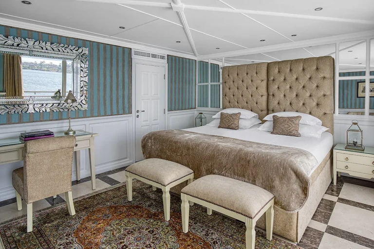 Suite with tufted headboard, desk and footstools on a rug