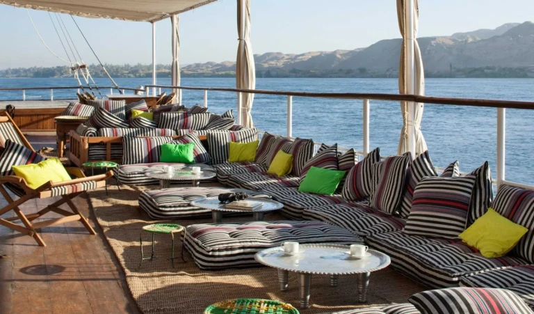 Shaded deck lounge with striped cushions on the Nile