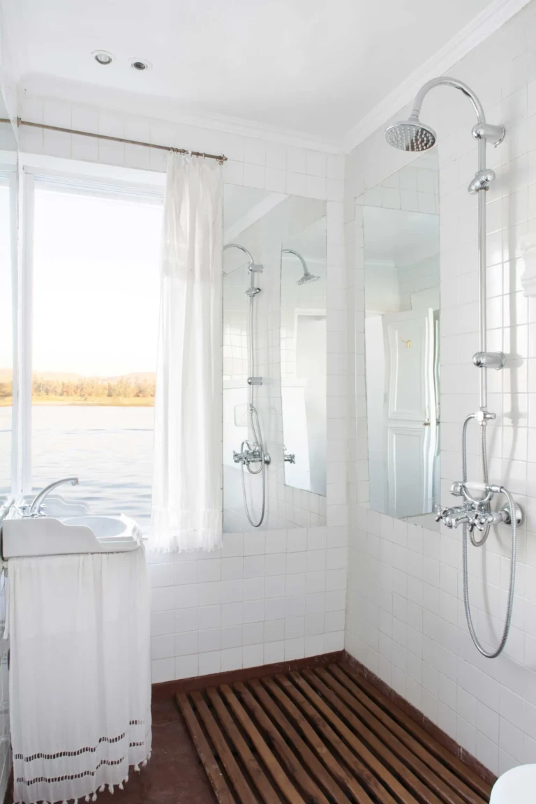 White bathroom with rainfall shower and window on the Meroe dahabiya
