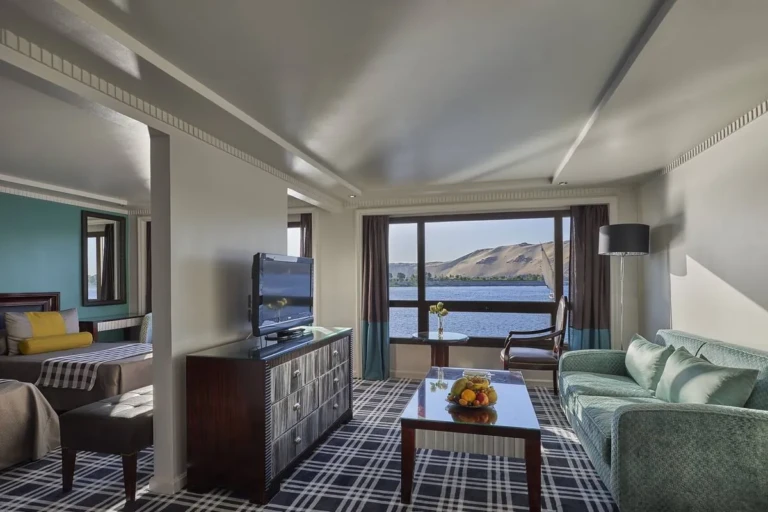 Suite sitting area with green sofa and Nile window on the Sun Ray