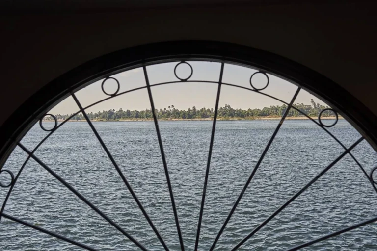 Nile view through an arched wrought-iron window on the Sun Ray