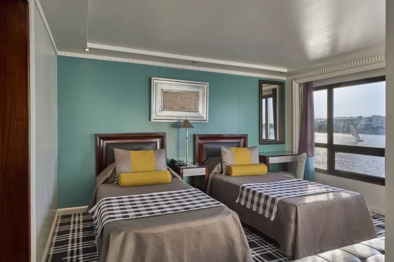 Twin beds with yellow cushions in a Sun Ray cabin