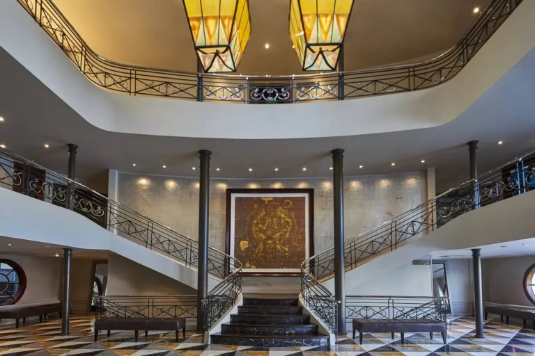 Double staircase under amber lanterns in the Sun Ray atrium