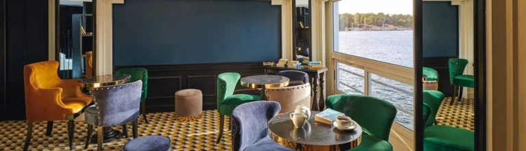 Movenpick MS Hamees bar with colourful armchairs and Nile windows