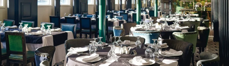 Movenpick MS Hamees restaurant with set tables and green chairs