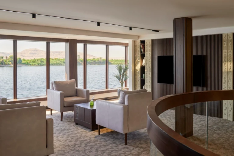 Royal Lily lounge with armchairs and floor-to-ceiling Nile windows