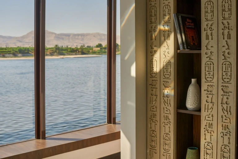 Window seat by the Nile with hieroglyph-carved shelving on Royal Lily