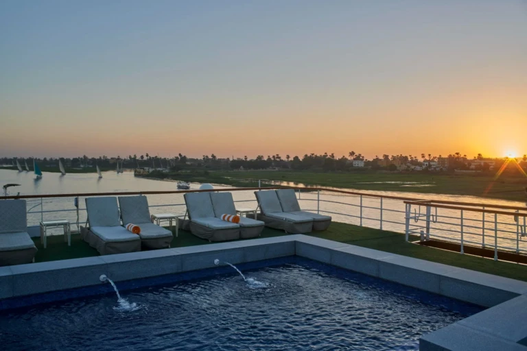 Royal Lily pool and loungers at sunset over the Nile
