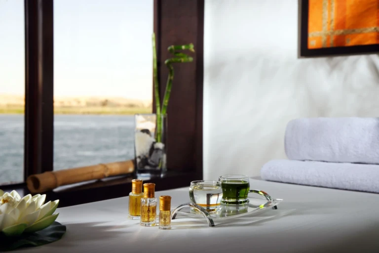 Spa table with oils and lotus flower by a Nile window on Royal Lily
