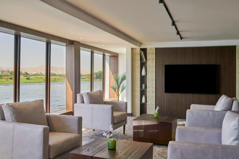 Lounge sofas and TV wall beside Nile windows on the Royal Lily