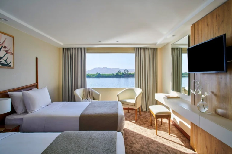 Royal Lotus twin cabin with armchairs facing a Nile window