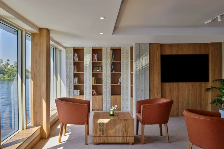 Royal Lotus library lounge with orange armchairs and bookshelves