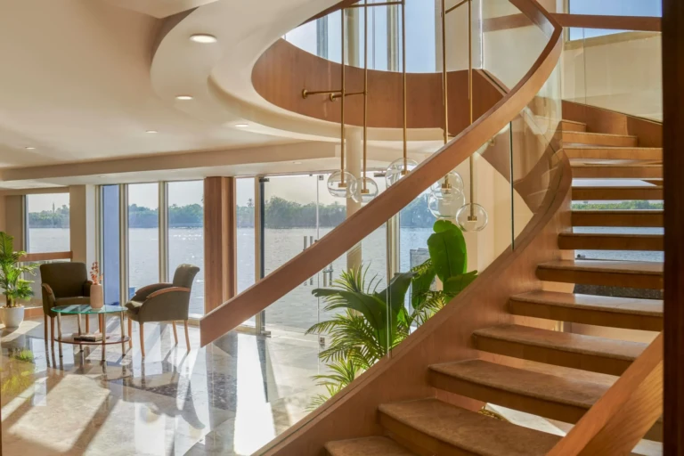 Wooden spiral staircase beside Nile windows on the Royal Lotus