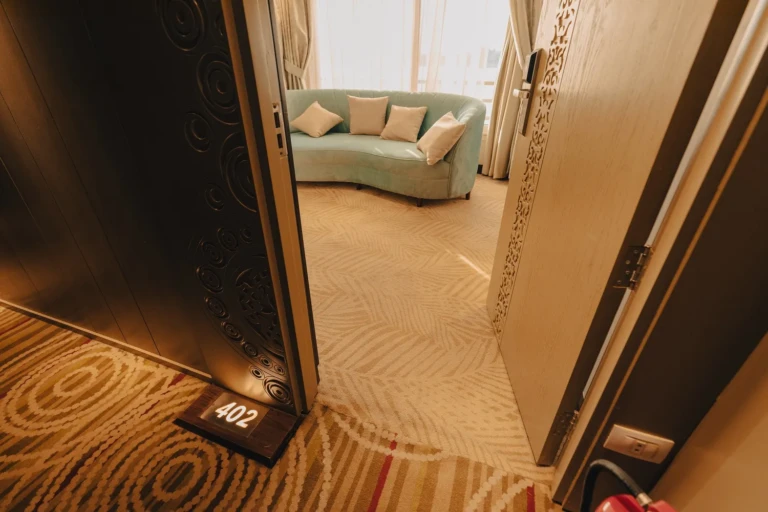 Open door of cabin 402 showing a curved sofa on the Nebu