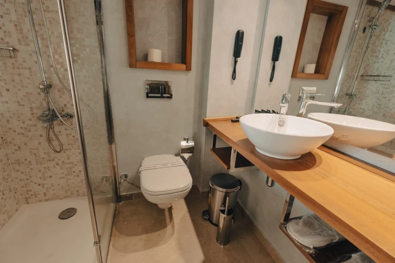 Cabin bathroom with twin sinks, shower and toilet on the Nebu