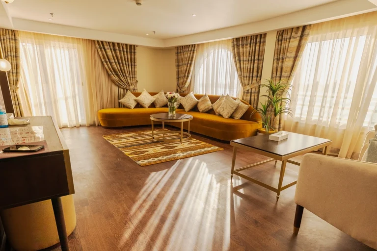 Suite living room with mustard sofa and wide windows on the Nebu