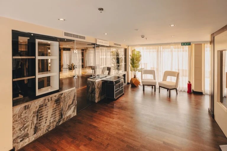 Open lounge with wooden floor and display cabinets on the Nebu