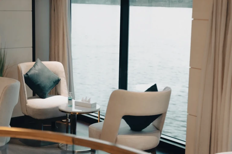 Two armchairs by a floor-to-ceiling Nile window on the Nebu