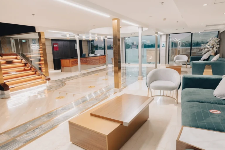 Nebu reception area with staircase and teal lounge seating