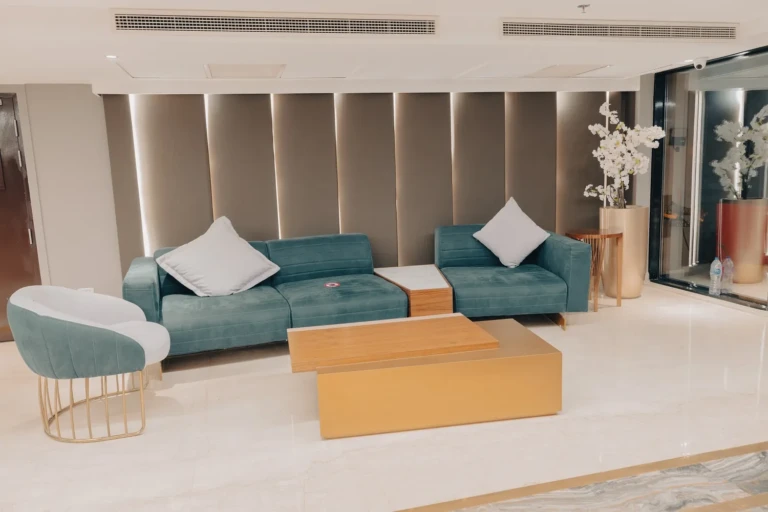 Teal sofas and wooden coffee table in the Nebu lobby