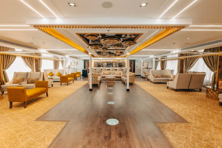 Long lounge with wooden walkway and gold ceiling trim on the Nebu