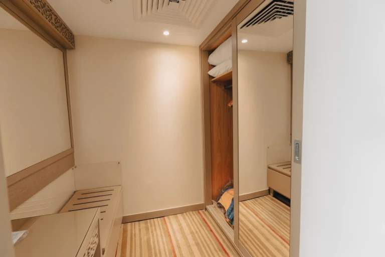 Cabin entry with mirrored wardrobe and dresser on the Nebu