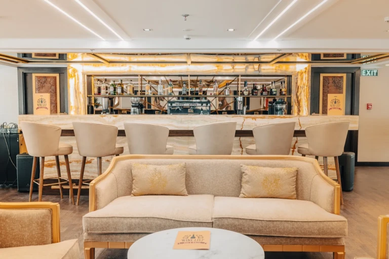 Nebu bar counter with stools and a cream sofa