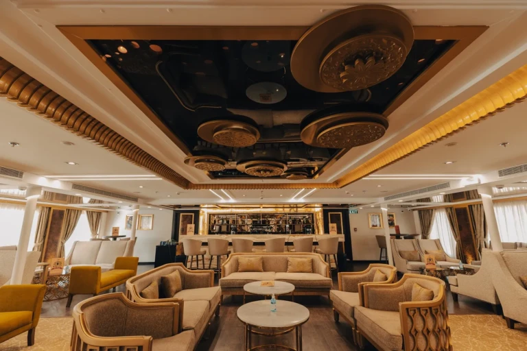Nebu lounge with armchairs, sofas and gold ceiling fixtures