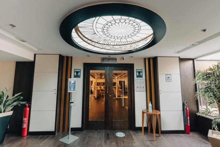 Glass doors under a round ornamental skylight on the Nebu